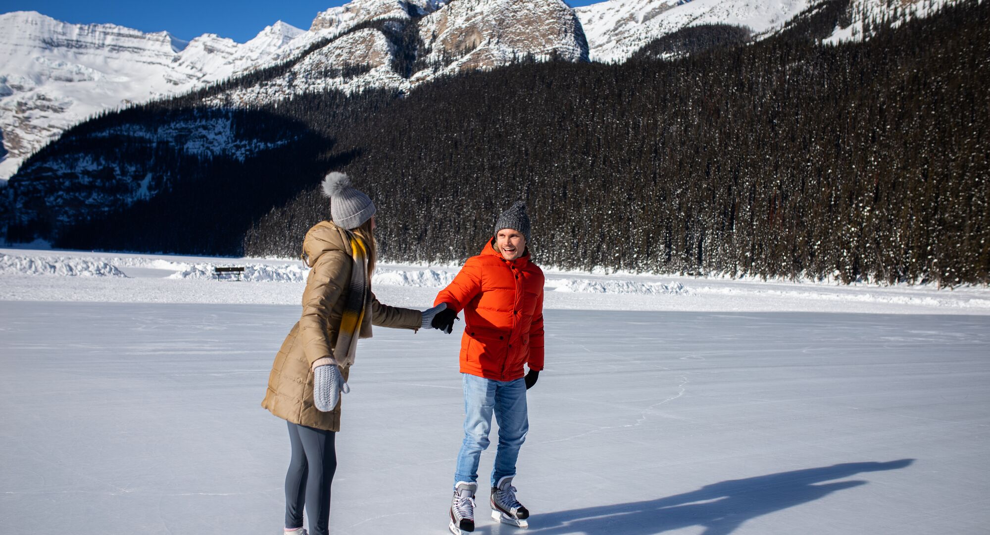 A couple skating on Lake Louise in the winter in Banff National Park